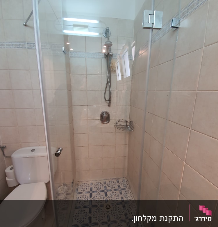 מקלחון זכוכית עם ראש מקלחת ומדף מתכת